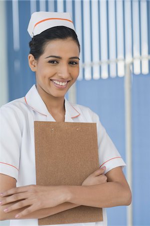 female doctor cap - Female nurse holding a clipboard and smiling, Gurgaon, Haryana, India Stock Photo - Rights-Managed, Code: 857-03554242