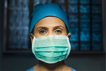 face of doctor and nurse - Portrait of a female surgeon wearing a surgical mask, Gurgaon, Haryana, India Stock Photo - Rights-Managed, Code: 857-03554297