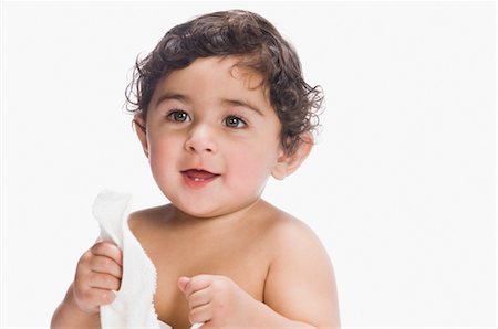 Baby boy holding a diaper and smiling Stock Photo - Rights-Managed, Code: 857-03554308