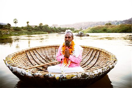 rivers of india - Sadhu worshipping in a coracle, Tungabhadra River, Hampi, Karnataka, India Stock Photo - Rights-Managed, Code: 857-03553631