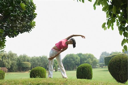 Woman stretching in a park, Gurgaon, Haryana, India Stock Photo - Rights-Managed, Code: 857-03553806