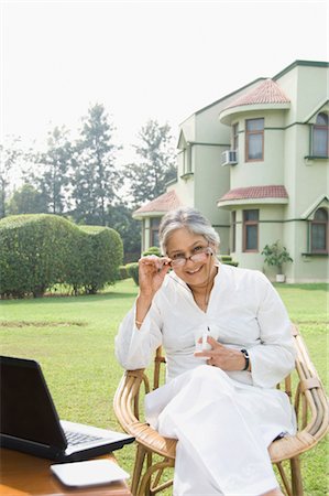 Woman with a laptop in a lawn, New Delhi, India Stock Photo - Rights-Managed, Code: 857-03553853