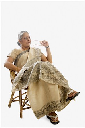 full length senior on white background - Woman sitting on a chair and day dreaming Stock Photo - Rights-Managed, Code: 857-03553885