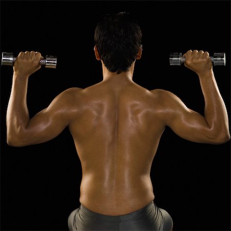 physique - Rear view of a man exercising with dumbbells Stock Photo - Rights-Managed, Code: 857-03553893