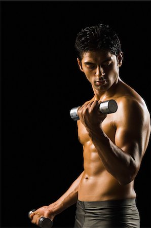 Man exercising with dumbbells Stock Photo - Rights-Managed, Code: 857-03553902