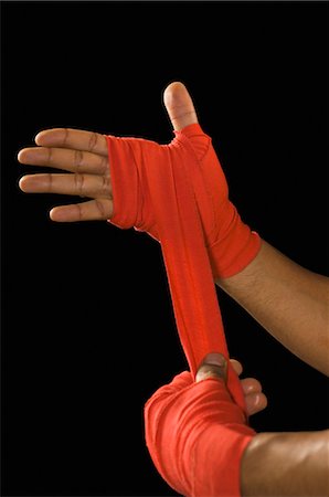 Male boxer wrapping crepe bandage on his hand Foto de stock - Con derechos protegidos, Código: 857-03553914