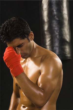 Close-up of a male boxer looking depressed Stock Photo - Rights-Managed, Code: 857-03553912