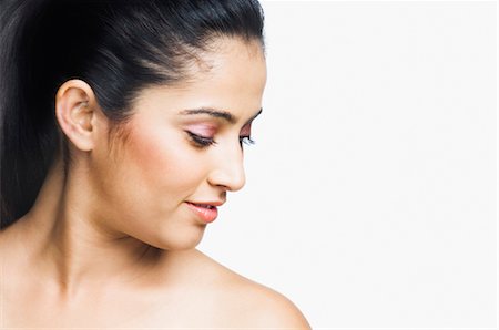 front of face looking down - Close-up of a young woman smiling Stock Photo - Rights-Managed, Code: 857-03553952