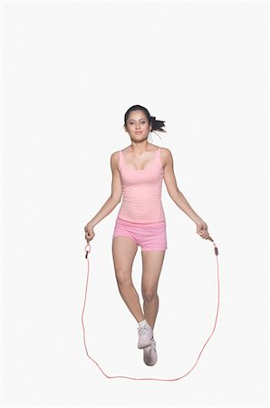 exercise indian women pic - Portrait of a young woman jumping rope Stock Photo - Rights-Managed, Code: 857-03553980