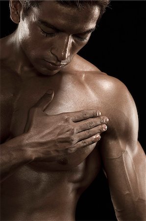 excercise black background - Close-up of a man flexing muscles Stock Photo - Rights-Managed, Code: 857-03570181