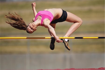 salto de altura - Young Female Athlete Performing High Jump Foto de stock - Con derechos protegidos, Código: 858-05604669