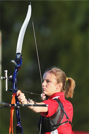 Young Female Archer Aiming at Target Stock Photo - Rights-Managed, Code: 858-05604888