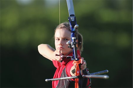 Young Female Archer Aiming at Target Stock Photo - Rights-Managed, Code: 858-05604896