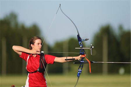 precisione - Young Female Archer Aiming at Target Fotografie stock - Rights-Managed, Codice: 858-05604891