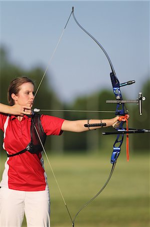 Young Female Archer Aiming at Target Stock Photo - Rights-Managed, Code: 858-05604892