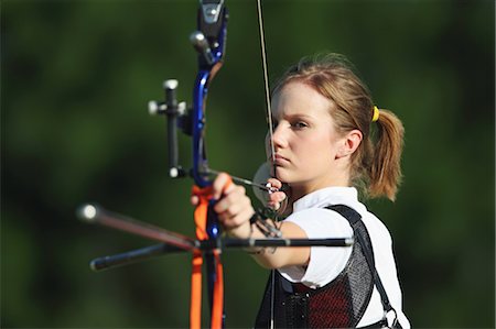 Young Female Archer Aiming at Target Stock Photo - Rights-Managed, Code: 858-05604903
