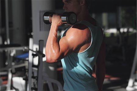 Young Man Taking Physical Training with Dumbbell Stock Photo - Rights-Managed, Code: 858-05605024