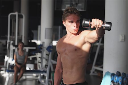 pecs - Young Man Taking Physical Training with Dumbbell Stock Photo - Rights-Managed, Code: 858-05605028