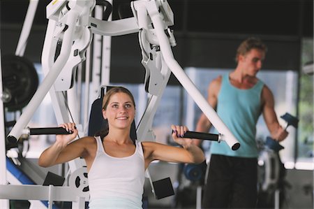 simsearch:858-05604777,k - Young Woman Taking Physical Training with a Exercise Machine Foto de stock - Con derechos protegidos, Código: 858-05605036