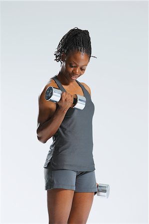 simsearch:858-05799284,k - African Woman Exercising With Dumbbells Foto de stock - Con derechos protegidos, Código: 858-05799277