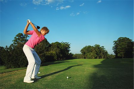 Golfer Preparing for Tee Shot Foto de stock - Con derechos protegidos, Código: 858-05799331