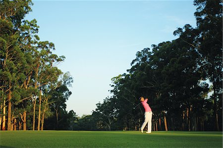 fairway - Man Swinging in Golf Club Fotografie stock - Rights-Managed, Codice: 858-05799343