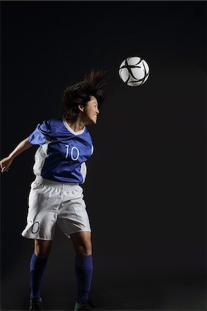 excercise black background - Japanese Young Sportswoman Hitting Soccer Stock Photo - Rights-Managed, Code: 858-06118959