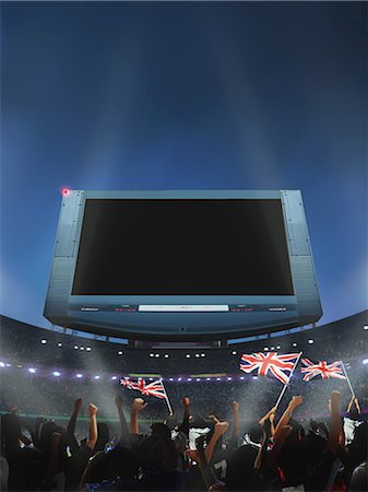 photo of a crowd of people at a game - Spectators Waving British Flag In Stadium, Screen Stock Photo - Rights-Managed, Code: 858-06159422