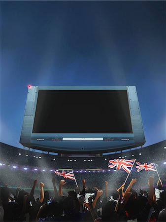 photo of a crowd of people at a game - Spectators Waving British Flag In Stadium, Screen Foto de stock - Con derechos protegidos, Código: 858-06159422