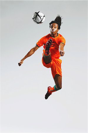 soccer jump - Man In Soccer Uniform With Ball Stock Photo - Rights-Managed, Code: 858-06617777