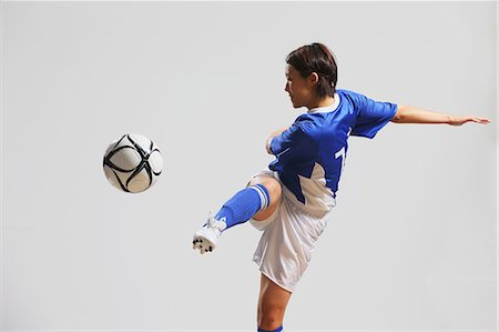 football players girls photo - Woman In Soccer Uniform Practicing With Ball Stock Photo - Rights-Managed, Code: 858-06617821