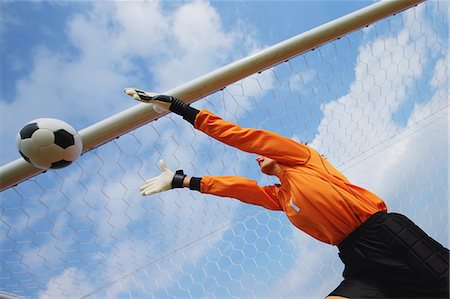 simsearch:600-06180194,k - Woman In Goal Keeper Uniform Playing Soccer Foto de stock - Con derechos protegidos, Código: 858-06617833