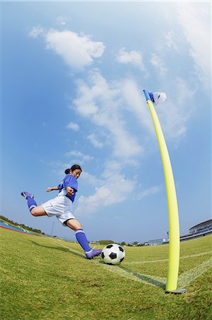 simsearch:858-06617776,k - Woman In Soccer Uniform Kicking a Ball Stock Photo - Rights-Managed, Code: 858-06617840
