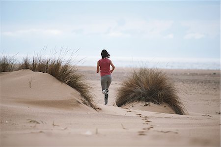 schlängeln - Young Woman Running Through Sand Dunes Stockbilder - Lizenzpflichtiges, Bildnummer: 858-06756017