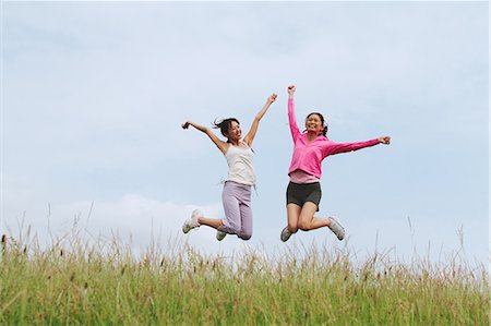 simsearch:858-06756054,k - Two Women Jumping Against Sky Stock Photo - Rights-Managed, Code: 858-06756041