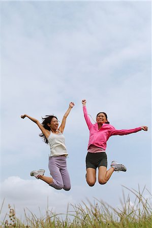 simsearch:858-06756054,k - Two Women Jumping Against Sky Stock Photo - Rights-Managed, Code: 858-06756042