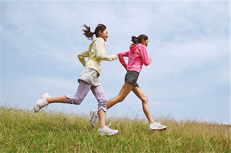 female runner side view - Friends Jogging On Grass Stock Photo - Rights-Managed, Code: 858-06756058