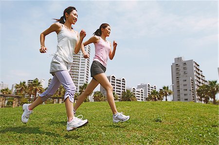 female runner side view - Friends Jogging On Grass Stock Photo - Rights-Managed, Code: 858-06756062