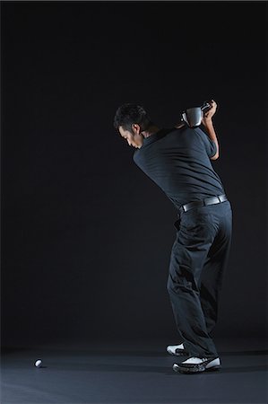 picture of black man playing golf - Golfer Preparing To Drive Golf Ball Stock Photo - Rights-Managed, Code: 858-06756109