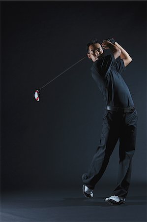 Golfer Swinging Driver After Taking Shot Stock Photo - Rights-Managed, Code: 858-06756110