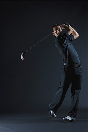 picture of black man playing golf - Golfer Swinging Driver After Taking Shot Stock Photo - Rights-Managed, Code: 858-06756110