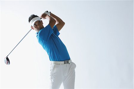 Portrait Of Golfer Swinging Foto de stock - Con derechos protegidos, Código: 858-06756149
