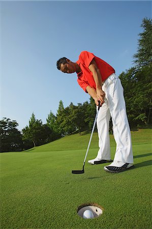 Golfer Putt Successfully Into Hole Stock Photo - Rights-Managed, Code: 858-06756168