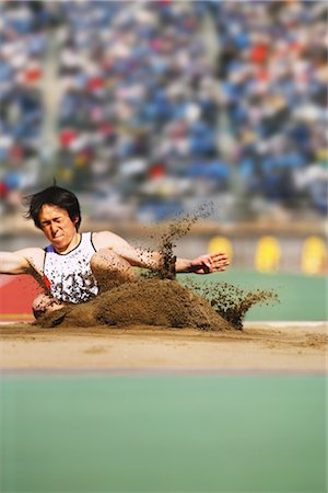 salto in lungo - Long Jumpers Landing Fotografie stock - Rights-Managed, Codice: 858-03046992