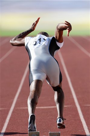 sprinters at starting blocks - Sprinter Leaving the Starting Blocks Stock Photo - Rights-Managed, Code: 858-03047366