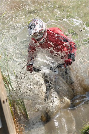 Mountain biker racing through a bog Stock Photo - Rights-Managed, Code: 858-03047561