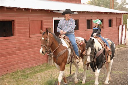 Homme et jeune fille sur les chevaux d'équitation Photographie de stock - Rights-Managed, Code: 858-03047668