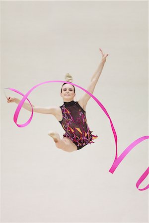 Front view of a teenage girl performing rhythmic gymnastics with ribbon Foto de stock - Con derechos protegidos, Código: 858-03048896
