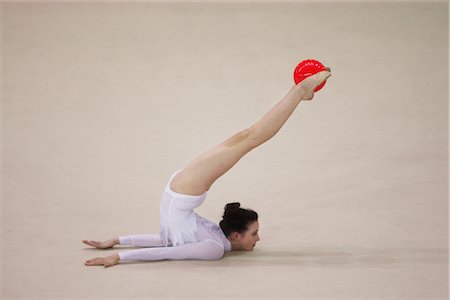 simsearch:858-03048929,k - Young woman performing rhythmic gymnastics with ball Foto de stock - Con derechos protegidos, Código: 858-03048926