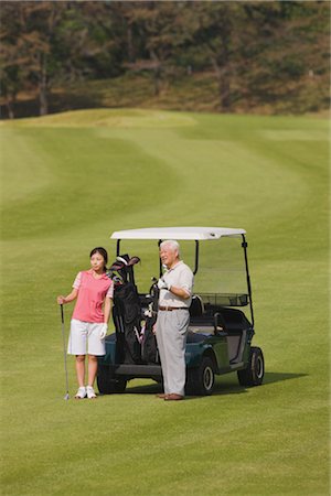 senior japanese golfer - Golfers holding putter near golf cart Stock Photo - Rights-Managed, Code: 858-03049308